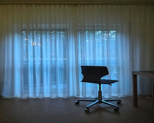 Soft natural sunlight filtering through sheer curtains onto a desk